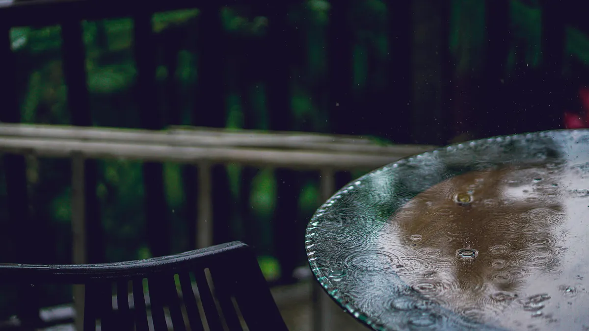 How Slip-Resistant Is a Stamped Concrete Patio? Rainy patio table surface with water droplets