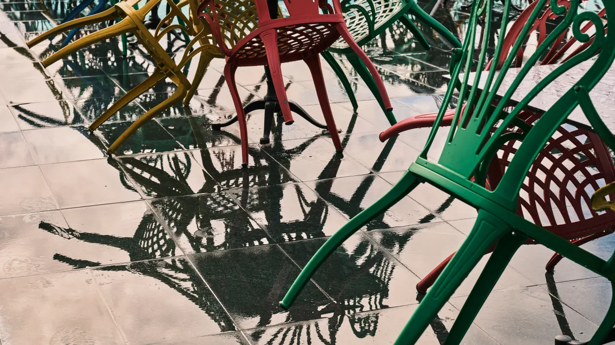 Wet outdoor patio with chairs and table