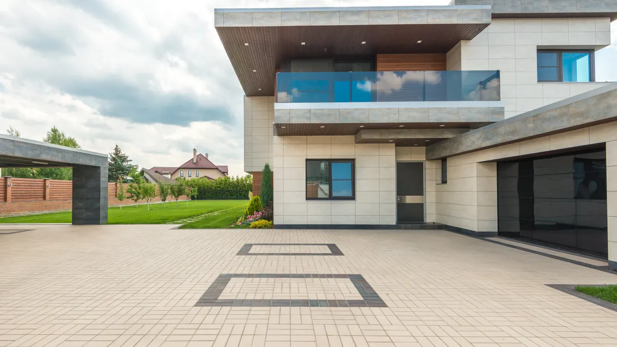 Modern home with a large patterned paved courtyard