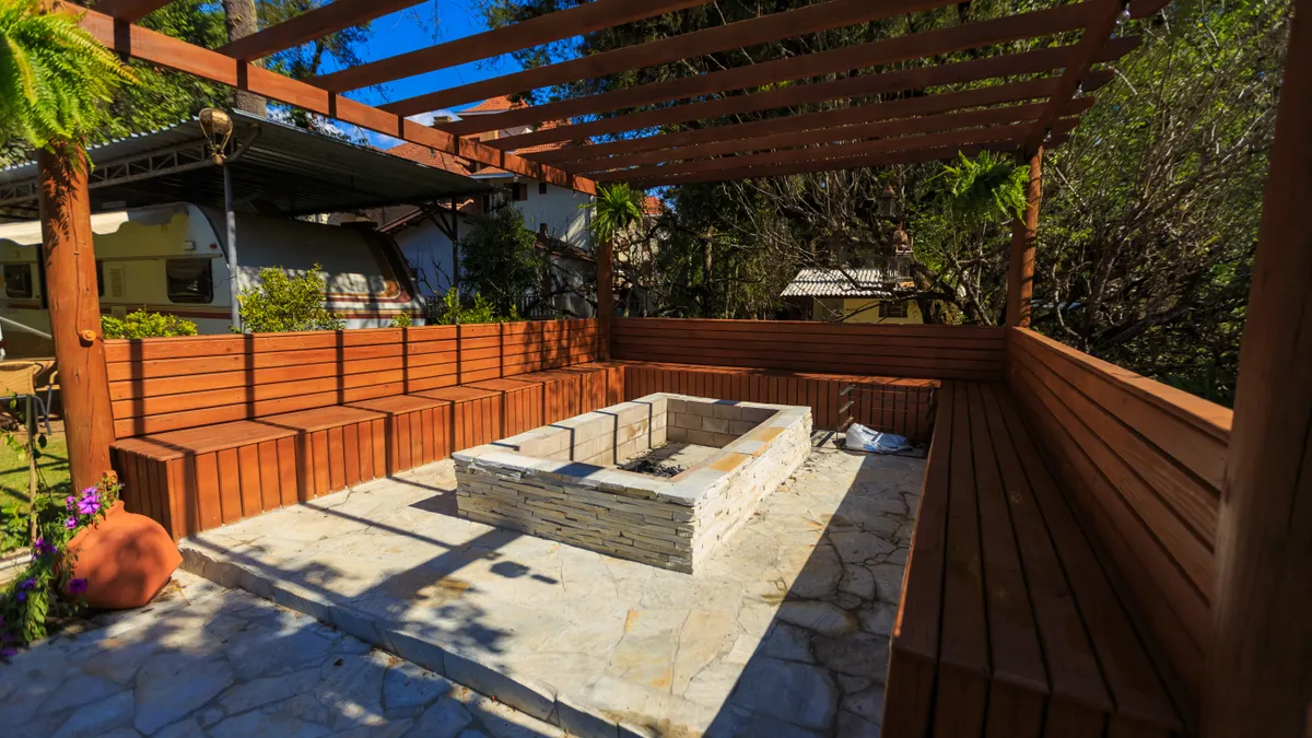 How to Design a Stamped Concrete Patio for Fire Pits Covered patio with built-in fire pit and wraparound benches