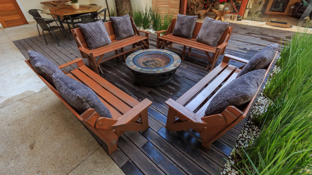 Circular seating area with a central fire pit on patio pavers