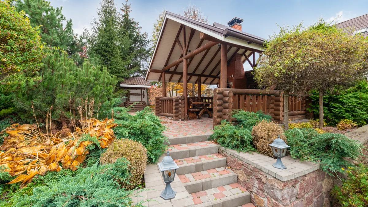 Backyard patio with stairs and retaining walls on a slope